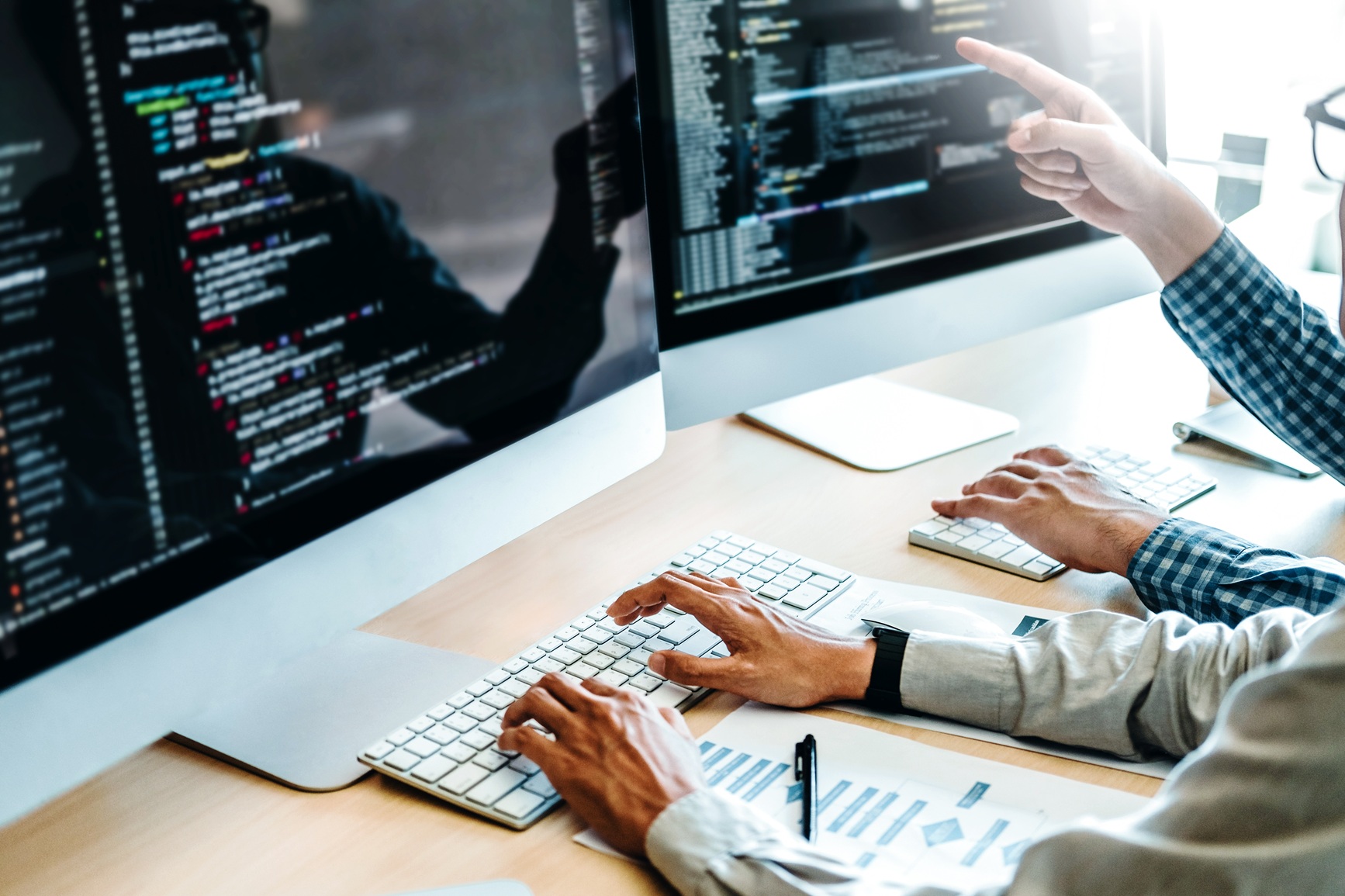 Image of computer screen and hands on a keyboard