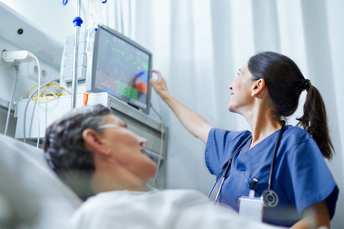 Healthcare professional monitors patient's heart function