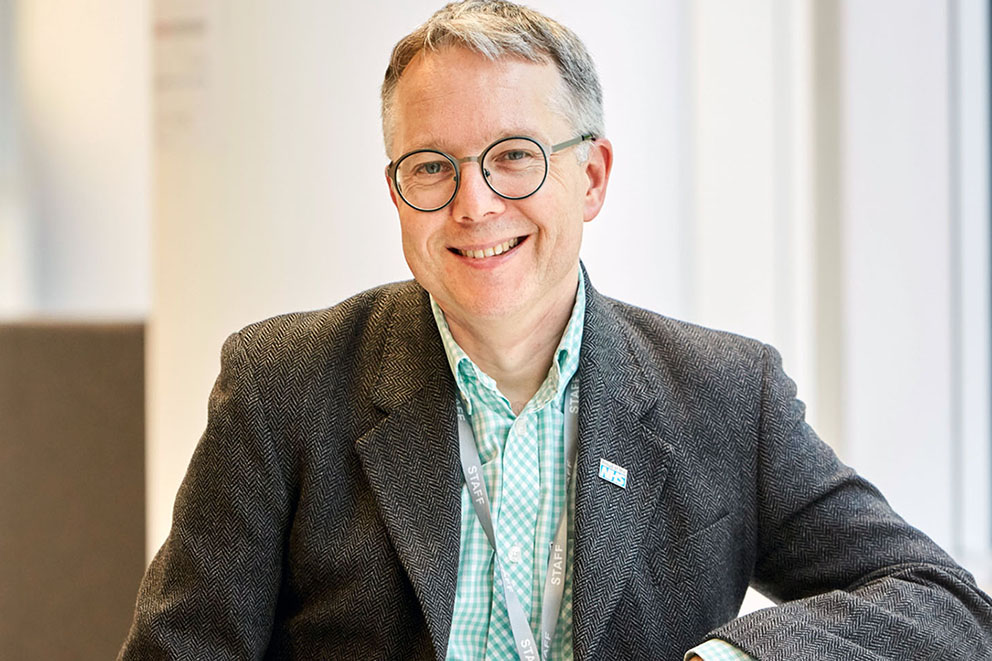 Image of Matt Edgar, Head of Design at NHS Digital, sat at a table