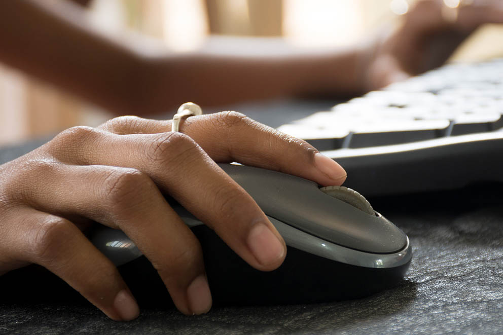 A computer user clicking a mouse