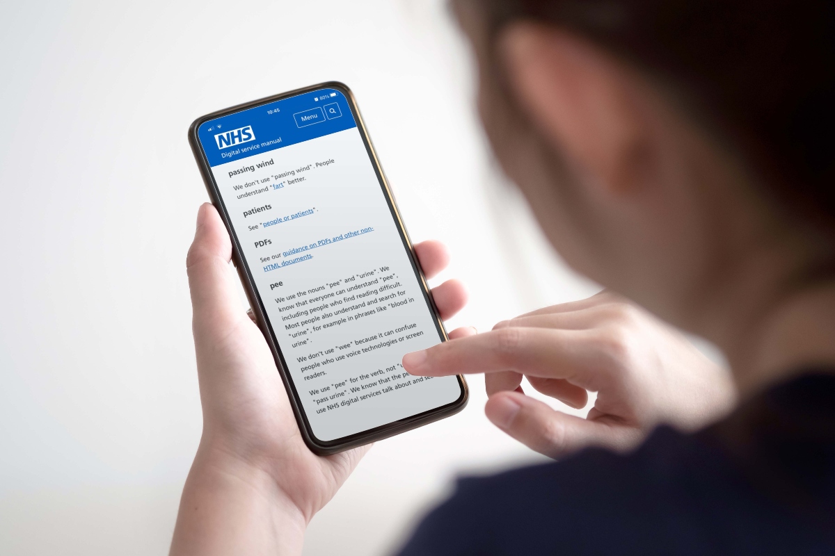 Woman looking at the NHS website on her phone
