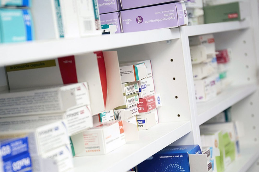Row of medicines on a pharmacy shelf