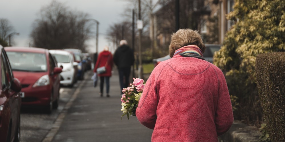 Lady walking down a street photographed from behind