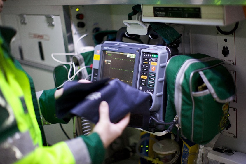 Paramedic operating Lifepak 15 monitor in ambulance